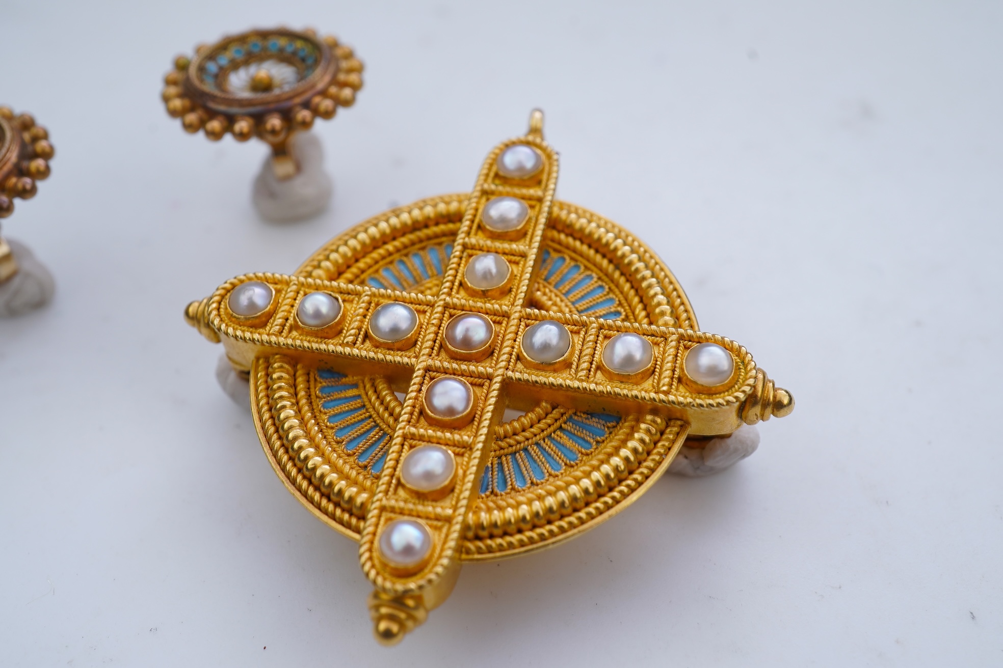 A gold, enamel and pearl pendant/brooch, mid 19th century, and a pair of earrings